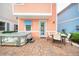 Paver patio with hot tub, outdoor dining set, and colorful exterior at 3062 Pirate Way, Kissimmee, FL 34747