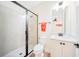 This bathroom features a tiled walk-in shower with black trim, white vanity, mirror, and towel rack at 3062 Pirate Way, Kissimmee, FL 34747