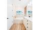 Well lit bathroom with soaking tub, vanity and wood tile flooring at 3062 Pirate Way, Kissimmee, FL 34747
