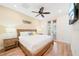 A serene bedroom boasts a ceiling fan, wood-look tile floor, and access to an outdoor patio at 3062 Pirate Way, Kissimmee, FL 34747