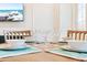 A dining room featuring a wooden table set with plates, bowls, and margarita glasses, ready for a delightful meal at 3062 Pirate Way, Kissimmee, FL 34747