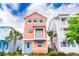 Charming peach-colored two-story home featuring blue shutters and accents with a small, decorative balcony at 3062 Pirate Way, Kissimmee, FL 34747