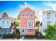 Charming two-story home with a light orange facade, blue shutters, and a cozy balcony at 3062 Pirate Way, Kissimmee, FL 34747