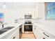 Bright kitchen featuring white cabinets, stainless steel appliances, stone counter tops, and modern fixtures at 3062 Pirate Way, Kissimmee, FL 34747