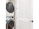 A well-organized laundry area with a stacked washer and dryer, offering convenience and efficiency at 3062 Pirate Way, Kissimmee, FL 34747