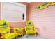 Covered patio featuring branded Adirondack chairs and table with coastal themed accents at 3062 Pirate Way, Kissimmee, FL 34747
