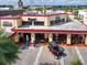 Aerial view of Ford's Garage showing the exterior design, including an antique car and outdoor dining at 3062 Pirate Way, Kissimmee, FL 34747