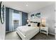 Cozy bedroom featuring large window, calming accents, and comfortable queen-sized bed at 3433 Briarwood Grove Dr, Ocoee, FL 34761