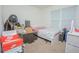 Bedroom with bed, window, and stacked belongings at 3479 Courtland Blvd, Deltona, FL 32738