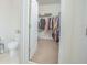 Spacious walk-in closet with ample storage space and organization, adjacent to a toilet at 3479 Courtland Blvd, Deltona, FL 32738