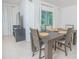 Dining area featuring a wooden table with seating for six, and natural light from a sliding door at 3479 Courtland Blvd, Deltona, FL 32738