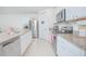 Bright kitchen features stainless steel appliances, granite countertops, and white cabinetry at 3479 Courtland Blvd, Deltona, FL 32738