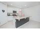 Modern kitchen features an island with granite countertops and white cabinets. Bon Appetit is written on the wall at 3479 Courtland Blvd, Deltona, FL 32738