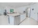 The Kitchen features an island with granite countertops and stainless steel appliances at 3479 Courtland Blvd, Deltona, FL 32738