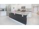 Modern kitchen island with granite countertops, a stainless steel refrigerator, and stylish white cabinetry at 3479 Courtland Blvd, Deltona, FL 32738