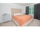 Comfortable bedroom featuring a king-size bed, neutral decor, and a bright window at 3479 Courtland Blvd, Deltona, FL 32738