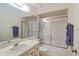 Cozy bathroom featuring patterned wall paper, a shower-tub combo and a large vanity at 3987 Lancashire Ln # 3987, Longwood, FL 32779