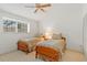 Light bedroom with a window, ceiling fan, and two twin beds with decorative floral bedding at 3987 Lancashire Ln # 3987, Longwood, FL 32779