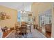 Elegant dining room with hardwood floors, a round table, and mirrored wall, creating an inviting atmosphere at 3987 Lancashire Ln # 3987, Longwood, FL 32779