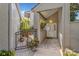 Inviting entryway with brick pavers, decorative gate, hanging light fixture, and plants creating a warm welcome at 3987 Lancashire Ln # 3987, Longwood, FL 32779