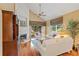 Living room with white brick fireplace, ceiling fan, and light hardwood flooring at 3987 Lancashire Ln # 3987, Longwood, FL 32779
