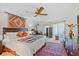 Spacious main bedroom with ceiling fan, large windows, and colorful accent rug at 3987 Lancashire Ln # 3987, Longwood, FL 32779