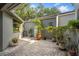 Serene patio with patterned brick, adorned with potted plants and foliage, creating a tranquil outdoor space at 3987 Lancashire Ln # 3987, Longwood, FL 32779