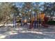 Community playground with slides, ladders, and other features, with mature trees nearby at 3987 Lancashire Ln # 3987, Longwood, FL 32779