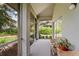 Outdoor screened in porch featuring decorative seating, plants, and lovely view of the grounds at 3987 Lancashire Ln # 3987, Longwood, FL 32779