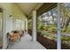 Outdoor screened in porch featuring decorative seating, plants, and lovely view of the grounds at 3987 Lancashire Ln # 3987, Longwood, FL 32779