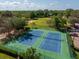 Aerial view of community tennis courts surrounded by green spaces showcases available recreational facilities at 3987 Lancashire Ln # 3987, Longwood, FL 32779