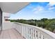 Private balcony with white railing offering panoramic views of lush greenery and neighborhood at 400 E Colonial Dr # 402, Orlando, FL 32803