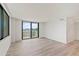 Bright bedroom featuring large windows leading to a balcony with city views at 400 E Colonial Dr # 402, Orlando, FL 32803