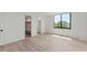 Bright bedroom featuring wood-look flooring, large window with a scenic view and two walk in closets at 400 E Colonial Dr # 402, Orlando, FL 32803