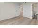 Empty bedroom shows multiple doors to the closet and the bathroom and light wood floors at 400 E Colonial Dr # 402, Orlando, FL 32803