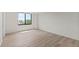 Bright bedroom with new floors and a large window bringing in natural light at 400 E Colonial Dr # 402, Orlando, FL 32803