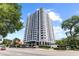 Modern high-rise building with white balconies, surrounded by lush landscaping and street view at 400 E Colonial Dr # 402, Orlando, FL 32803