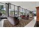 Lobby featuring modern furniture, patterned rugs, large windows, and architectural columns at 400 E Colonial Dr # 402, Orlando, FL 32803