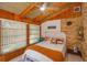 Cozy bedroom featuring vaulted wood ceiling, a brick accent wall, and warm natural light at 470 Oak Haven Dr # 470, Altamonte Springs, FL 32701