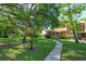 A brick home with a lush, tree-lined lawn and a serene walkway creates a welcoming facade at 470 Oak Haven Dr # 470, Altamonte Springs, FL 32701