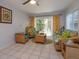 Bright living room with wicker furniture, tile flooring, and sliding glass doors to the outside at 470 Oak Haven Dr # 470, Altamonte Springs, FL 32701