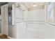 Bright white bathroom with a tub, stylish tile floor, and a large mirror at 4927 Fiske Cir, Orlando, FL 32826