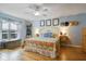 Bright bedroom with hardwood floors and a large window. A ceiling fan provides comfort at 4927 Fiske Cir, Orlando, FL 32826