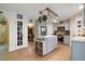 Charming kitchen with stainless appliances, kitchen island, and stylish pot rack at 4927 Fiske Cir, Orlando, FL 32826