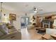 Cozy living room with hardwood floors, TV fireplace, and plenty of natural light at 4927 Fiske Cir, Orlando, FL 32826
