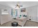 Stylishly decorated bedroom featuring a queen-size bed, a ceiling fan, and white painted furniture at 508 Boxelder Ave, Altamonte Springs, FL 32714