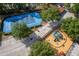 Aerial view of a community playground and blue tennis courts at 6107 Metrowest Blvd # 104, Orlando, FL 32835