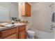 Bright bathroom features a shower-tub combo and a wooden vanity at 6107 Metrowest Blvd # 104, Orlando, FL 32835