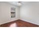 Bright bedroom featuring a ceiling fan, window with blinds, and hardwood flooring at 6107 Metrowest Blvd # 104, Orlando, FL 32835