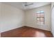 The bedroom has a ceiling fan, hard floors and a window at 6107 Metrowest Blvd # 104, Orlando, FL 32835